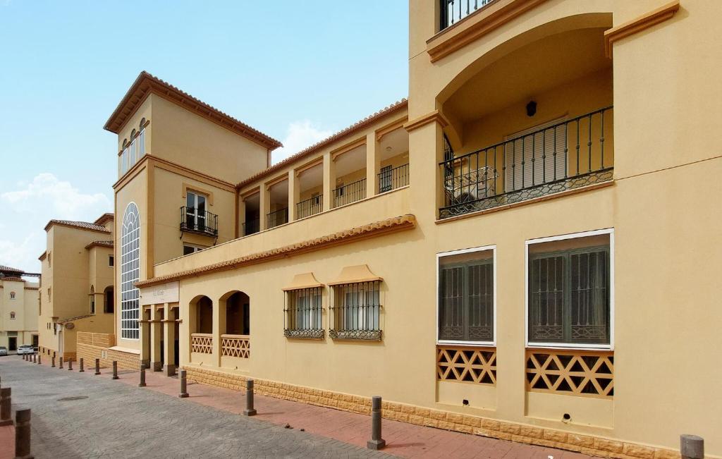 a building with balconies on the side of a street at 2 Bedroom Stunning Apartment In Nerja in Nerja