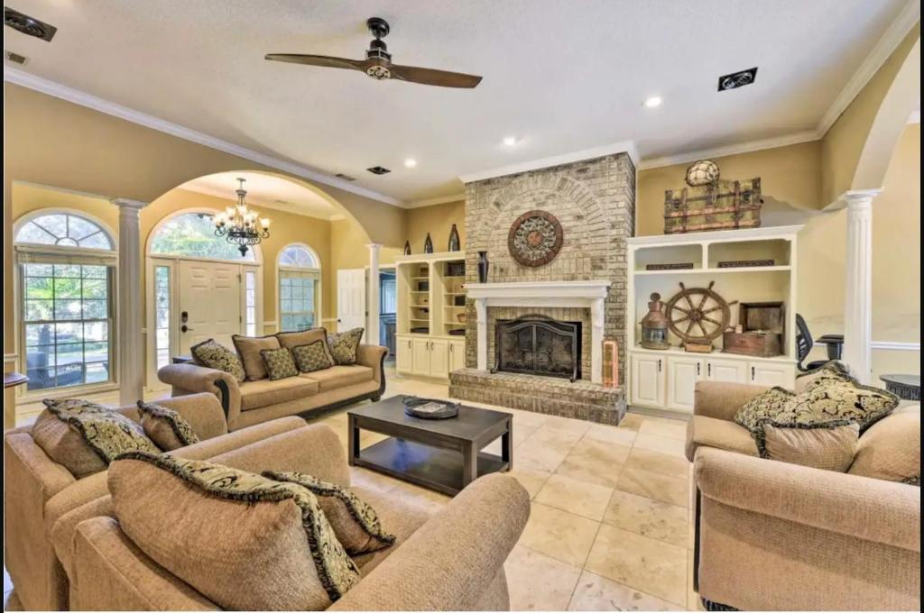 a living room with couches and a fireplace at Georgia's Nature Retreat On Old Mill Pond in Statesboro