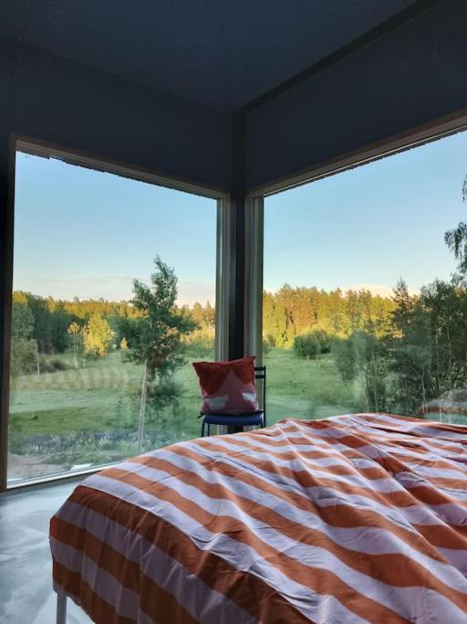 a bedroom with a bed and a large window at Huoneisto Sipoossa in Helsinki