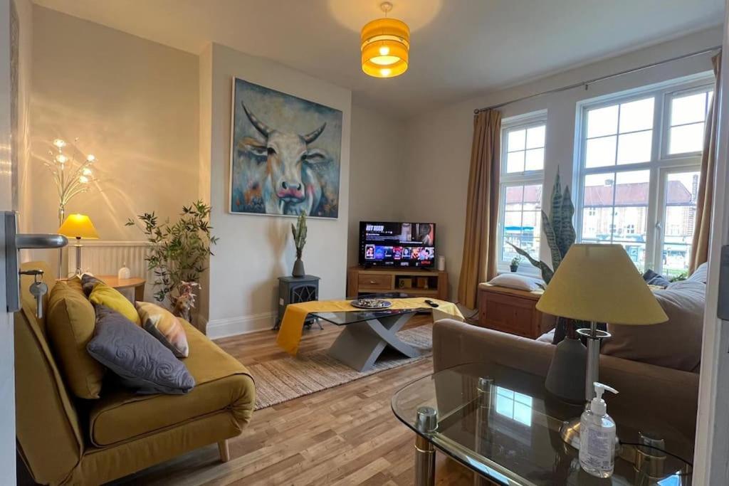 a living room with a couch and a table at Home in London, N14 nearby Trent Park and Alexandra Palace in East Barnet