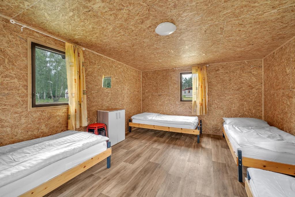 Postel nebo postele na pokoji v ubytování Chatová osada Bílý Kámen