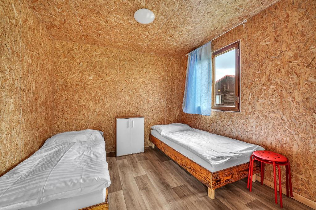 Postel nebo postele na pokoji v ubytování Chatová osada Bílý Kámen