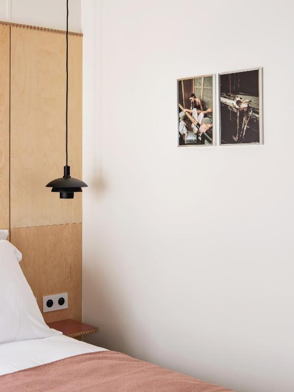 a bedroom with a bed and a picture on the wall at New Hotel Opéra in Paris