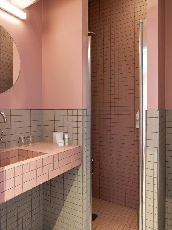a bathroom with a sink and a shower at New Hotel Opéra in Paris