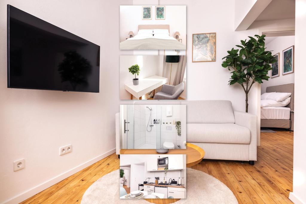 Una sala de estar con un sofá blanco y un televisor. en Design Suite! Familie - Küche - Zentral, en Wuppertal