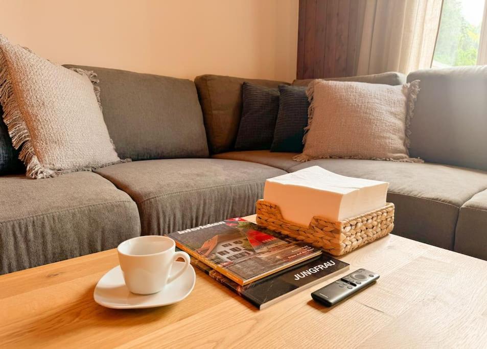 a coffee table with a cup of coffee and books at City Center View Apartment 2 in Interlaken