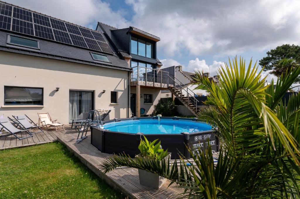 a house with a swimming pool in the backyard at Villa Clémarine in Saint-Philibert