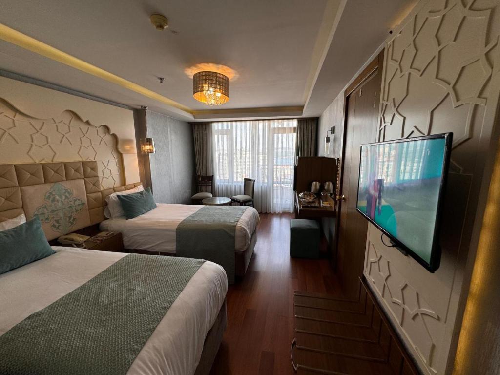 A bed or beds in a room at Grand Star Hotel Premium