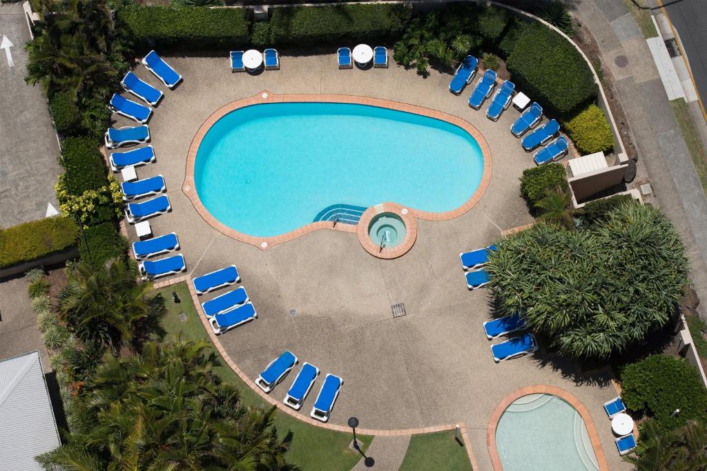 an overhead view of a swimming pool with lounge chairs and a resort at BreakFree Longbeach Resort in Gold Coast