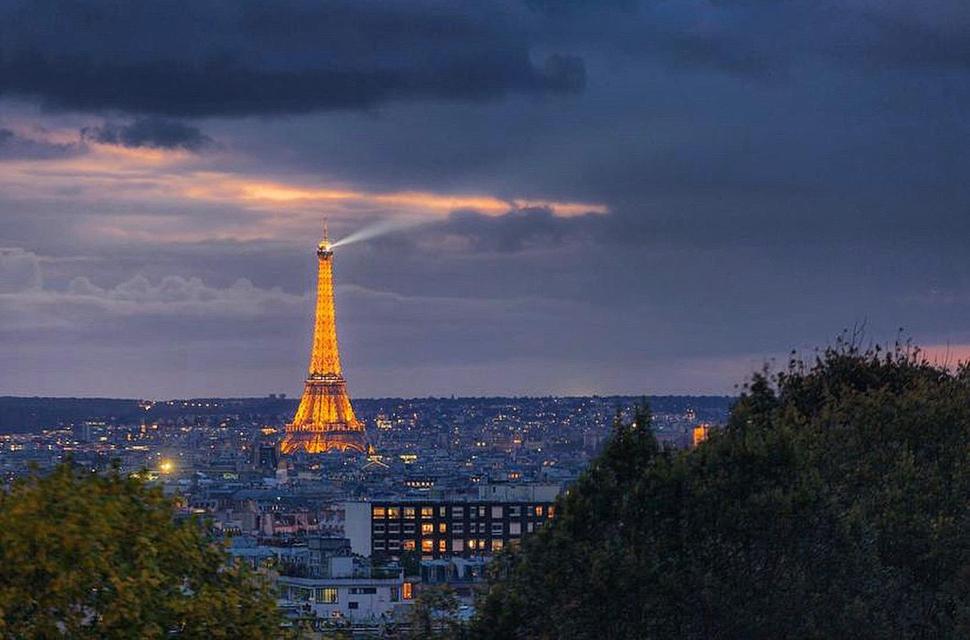 - une vue sur la tour Eiffel la nuit dans l'établissement Charmant Studio à Belleville, à Paris