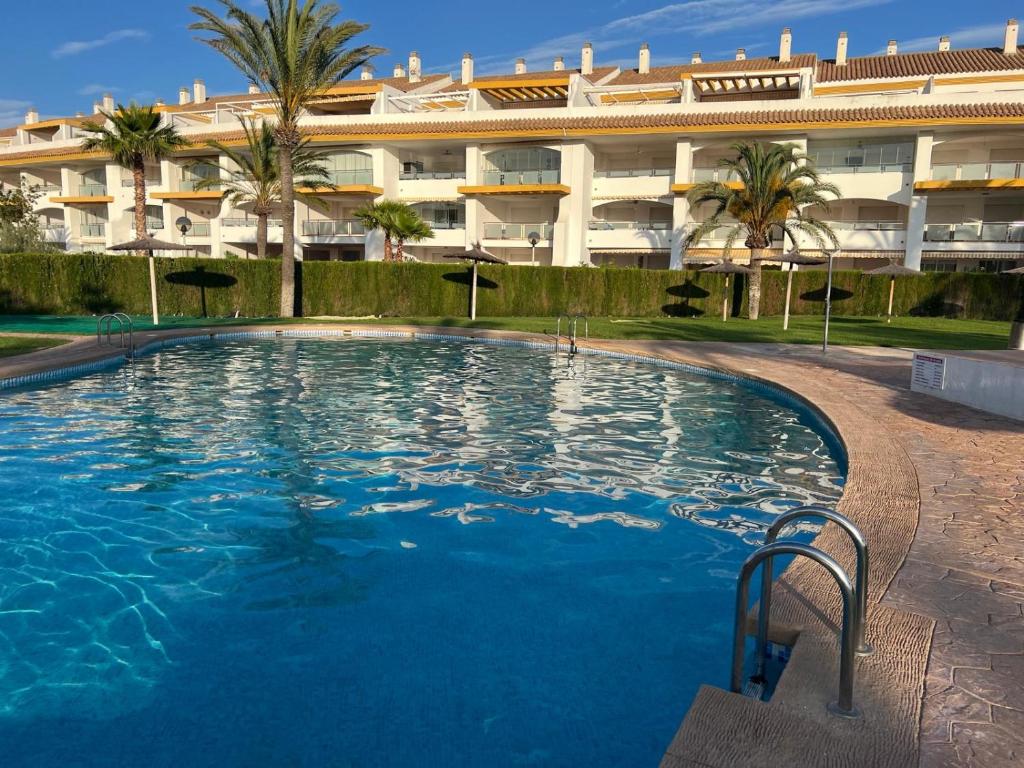 a swimming pool in front of a large building at Torresnostra see experience in Torreblanca