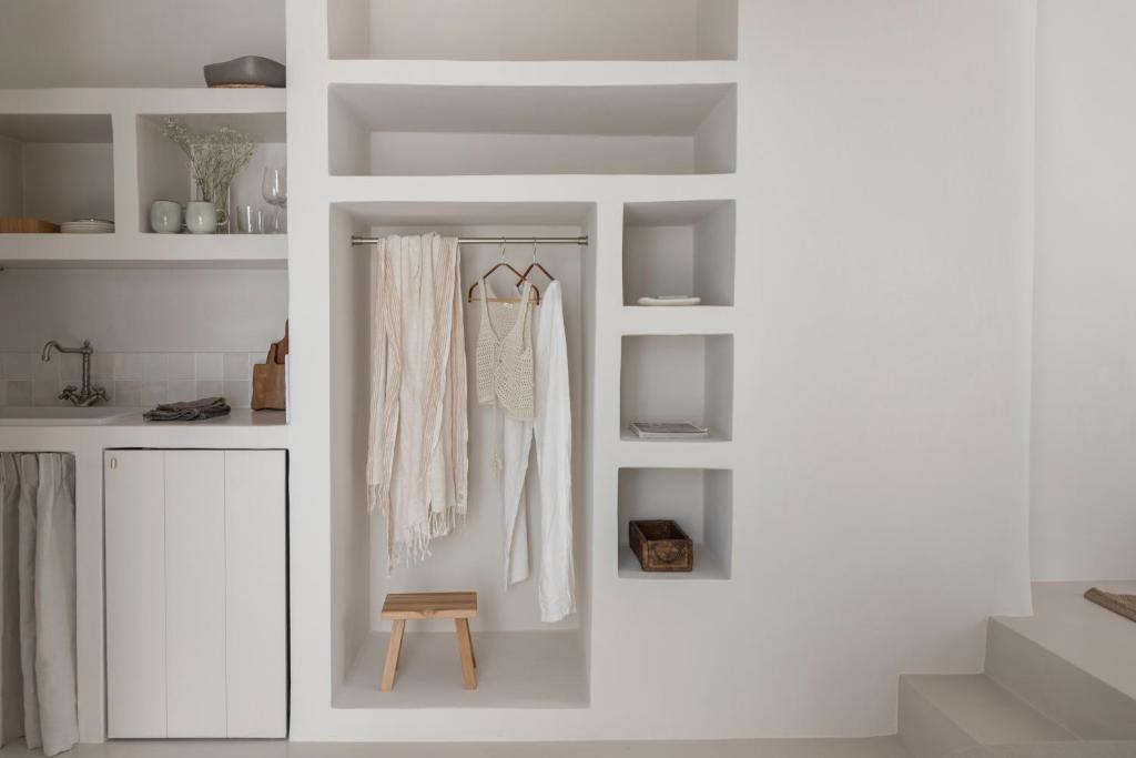 a room with white walls and white shelves at Om Living Milos in Pollonia