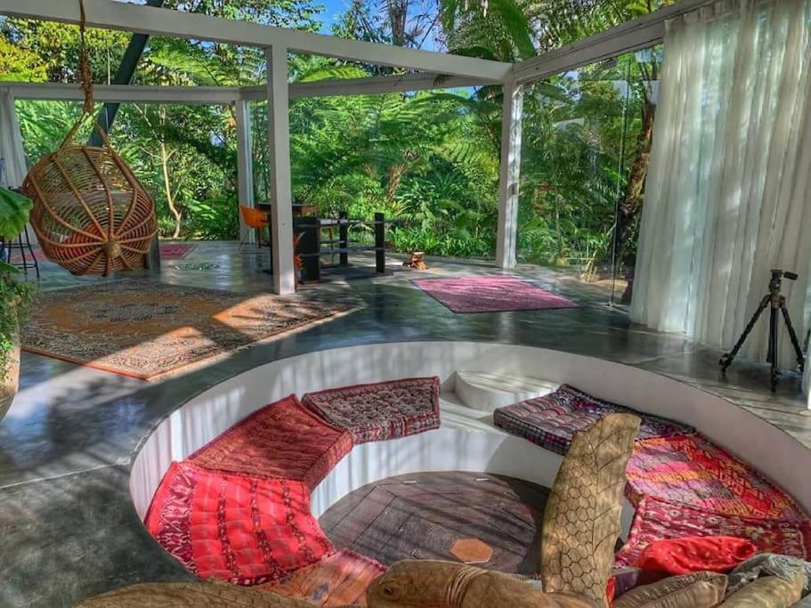 a room with a table and some carpets on the floor at Castle in the sky mountain bliss, Kintamani area in Plaga