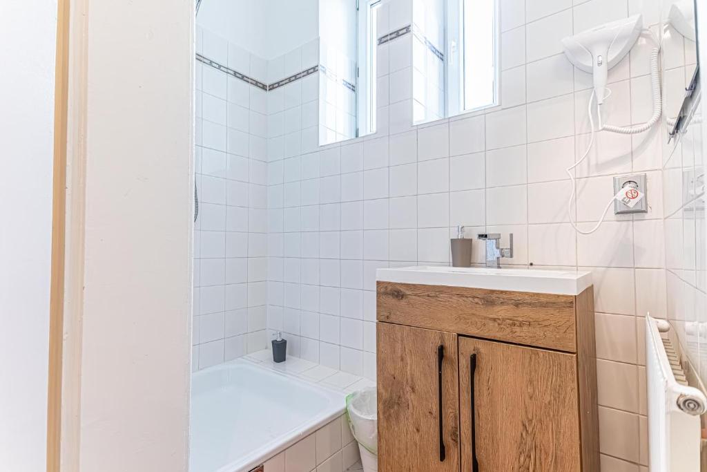 a bathroom with a sink and a toilet and a shower at Convenient 3-BR Shared Apt, 15 Min to Landstraße Hub in Vienna