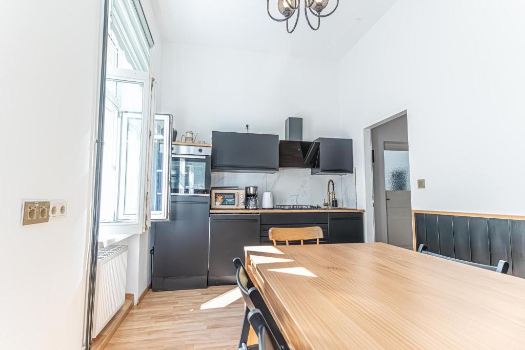a kitchen with a wooden table and a wooden counter top at Convenient 3-BR Shared Apt, 15 Min to Landstraße Hub in Vienna