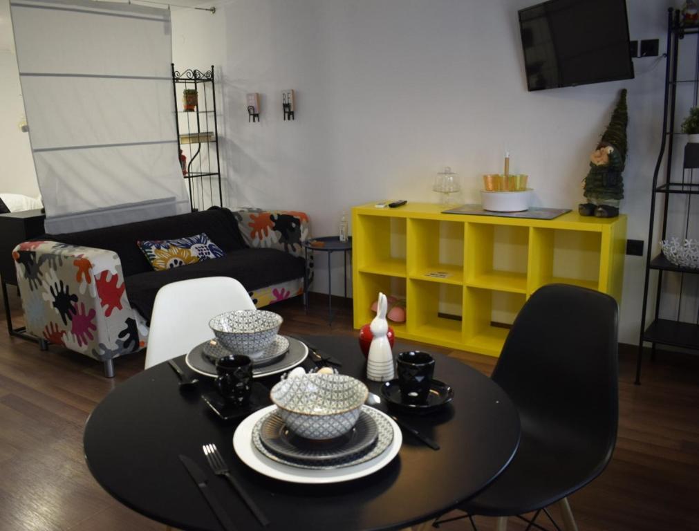 a living room with a table and a yellow shelf at colored houses in Ierapetra