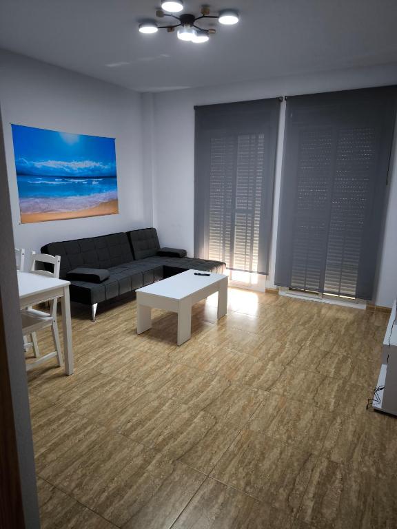 a living room with a couch and a table at BALERMAPLAYA calle lago in Balerma
