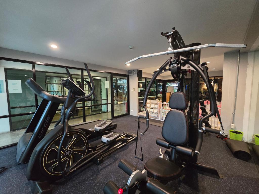 A compact gym with cardio equipment and a multi-station strength machine.