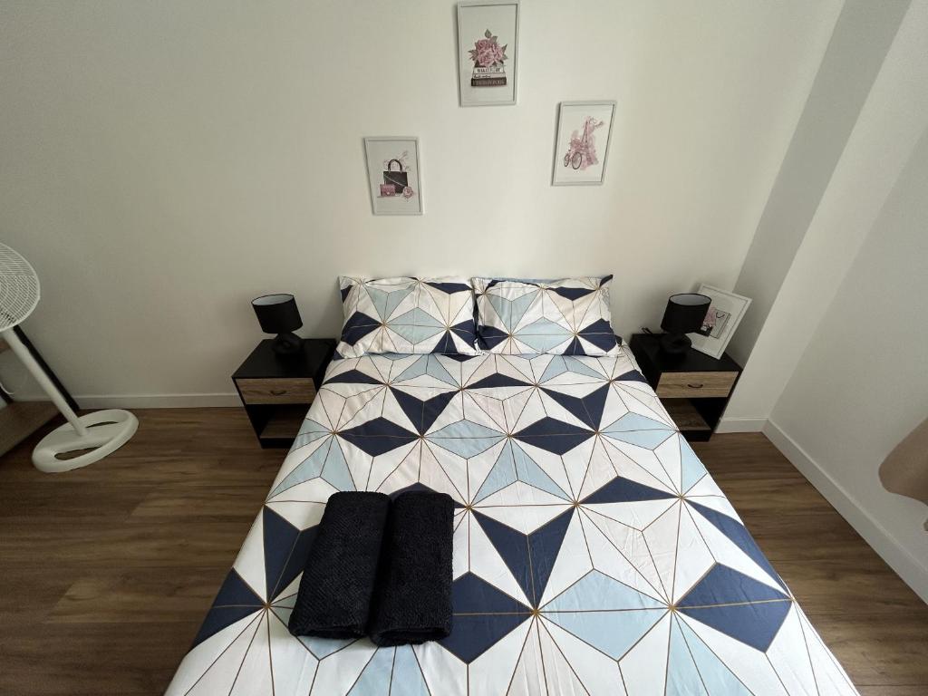 a bedroom with a bed with black socks on it at Centre Ville avec Garage - Parking in Troyes