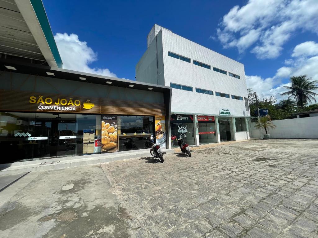 two motorcycles parked in front of a building at Pousada Anadia in Cajá