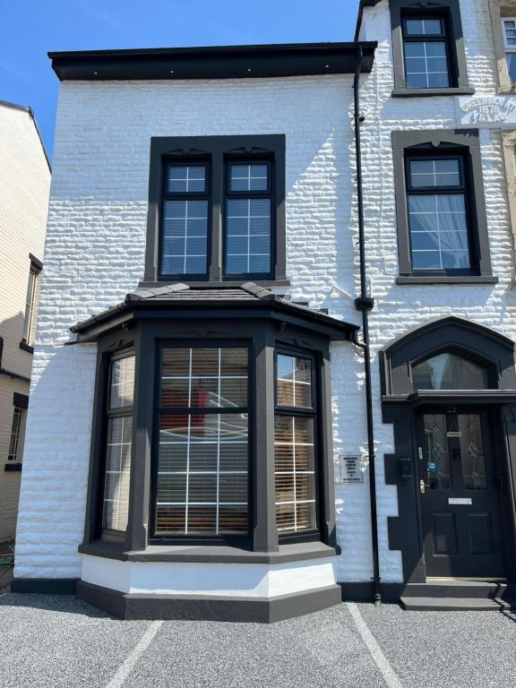 a building with black windows and a door at Marston town centre villa in Blackpool
