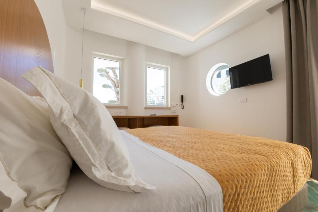 Postel nebo postele na pokoji v ubytování Maggiano Boutique Hotel
