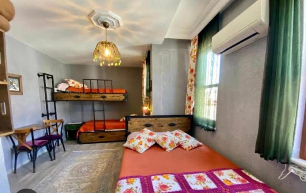 a bedroom with a bed and a table in it at Velespit Hotel in Antalya