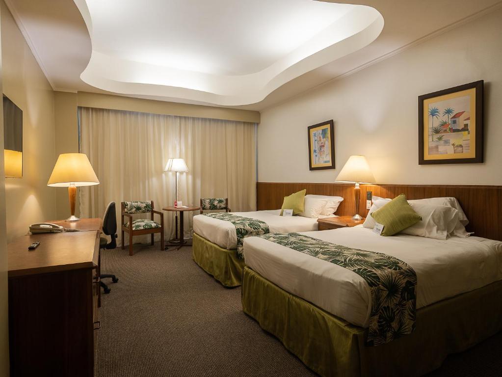 Postel nebo postele na pokoji v ubytování Hotel Palace Guayaquil