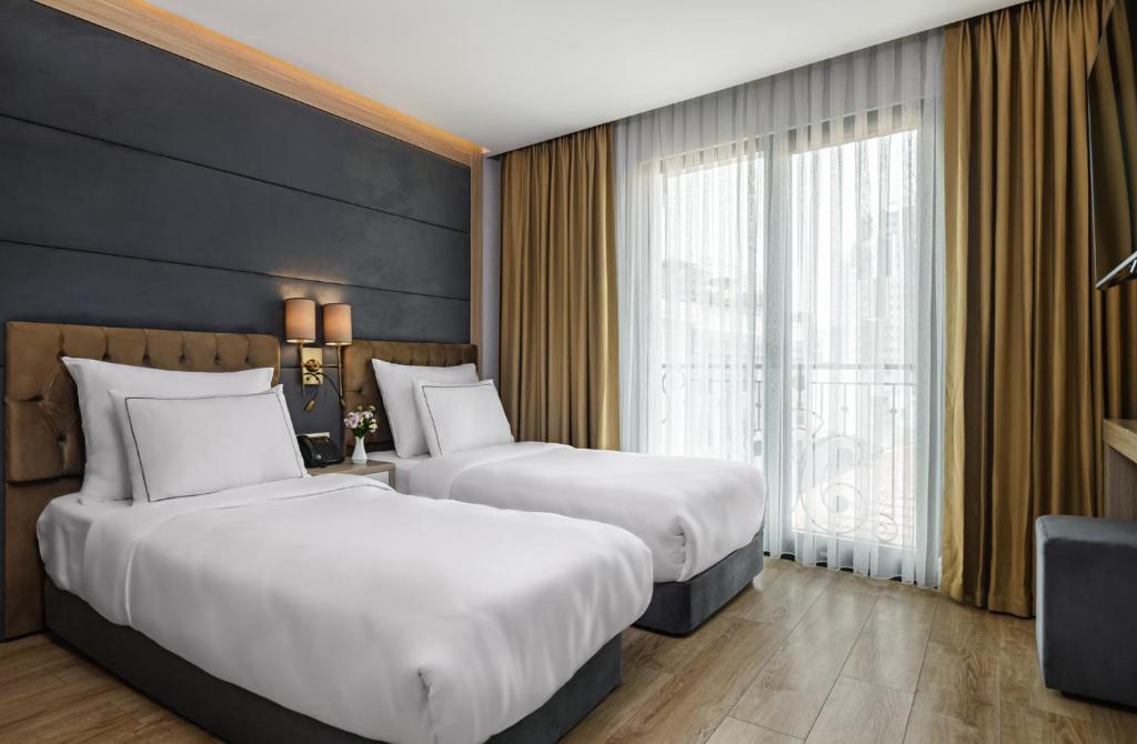 Postel nebo postele na pokoji v ubytování Gleam Bomonti Hotel