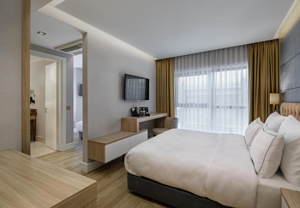 Postel nebo postele na pokoji v ubytování Gleam Bomonti Hotel