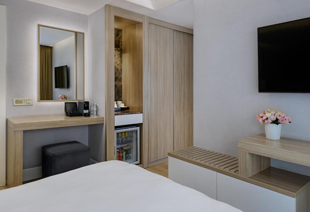 Postel nebo postele na pokoji v ubytování Gleam Bomonti Hotel