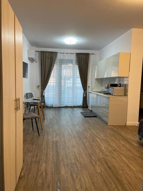 a living room with a kitchen and a dining room at Best View luxury in Costinesti