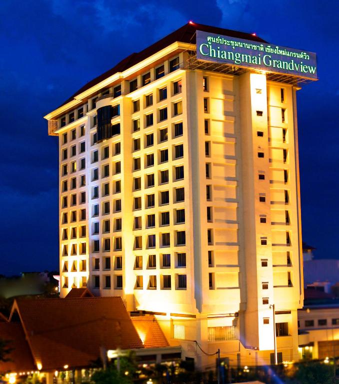 a tall white building with a sign on top of it at Chiangmai Grandview Hotel & Convention Center in Chiang Mai