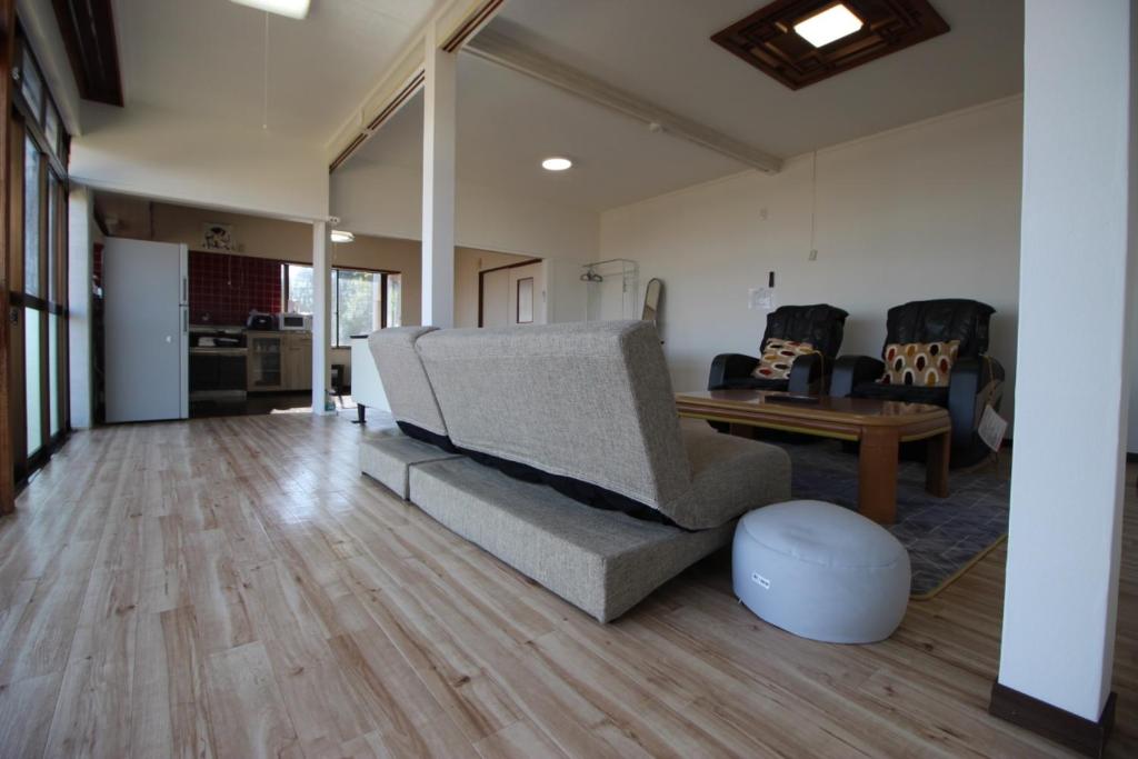 a living room with a couch and a table at Fukutokukashiya - Vacation STAY 16907 in Kagoshima