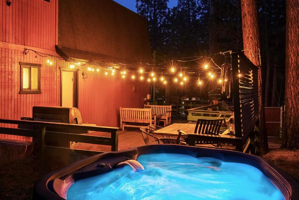a hot tub on a patio with lights at Sugar in the Raw Cabin - Hot Tub in Sugarloaf