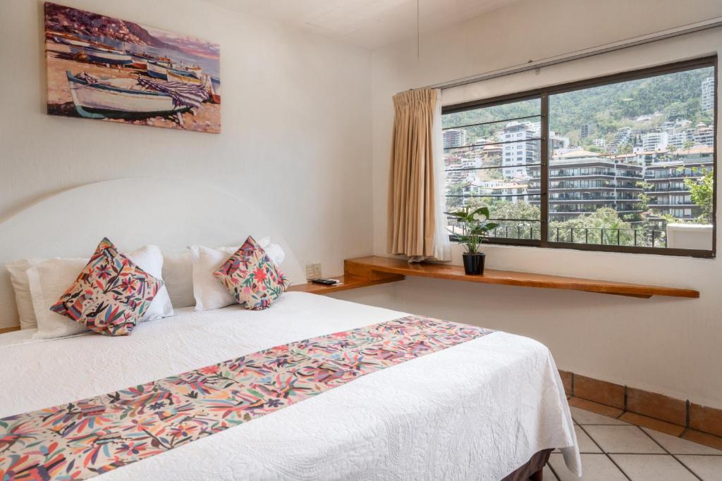 Postel nebo postele na pokoji v ubytování Hotel Eloisa