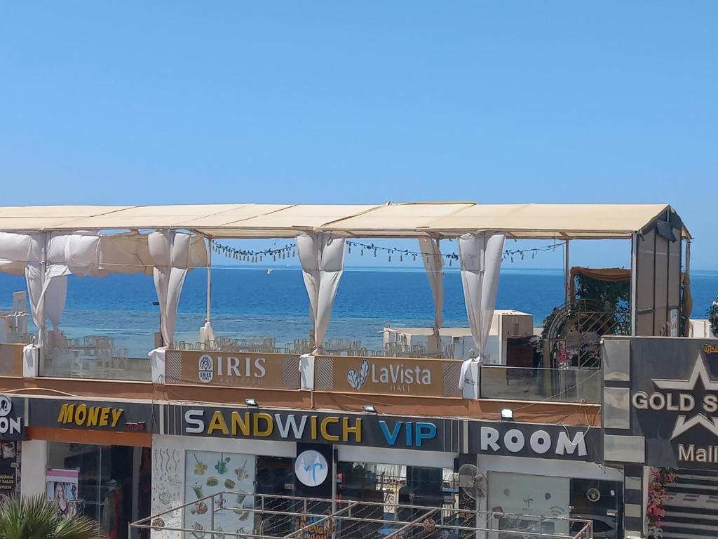 a building with a marquee with the ocean in the background at شقة فندقية على البحر 3 in Hurghada