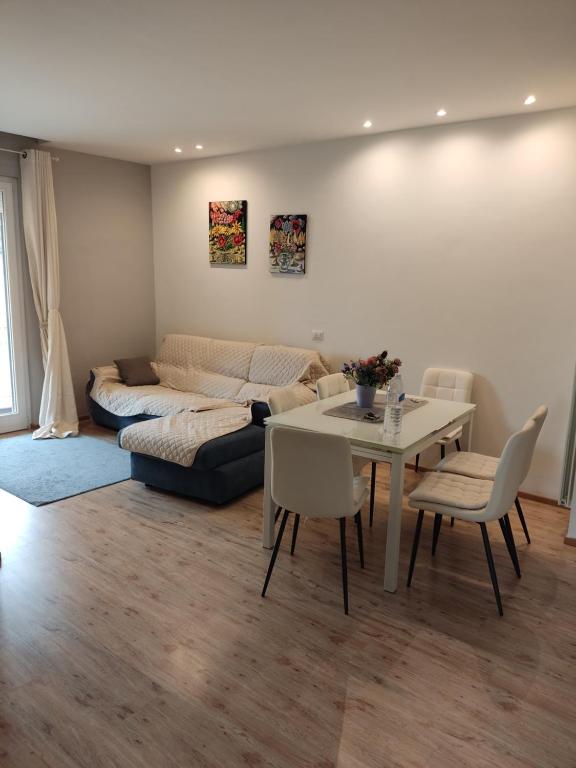 a living room with a couch and a table and chairs at Casa Berna in Rome