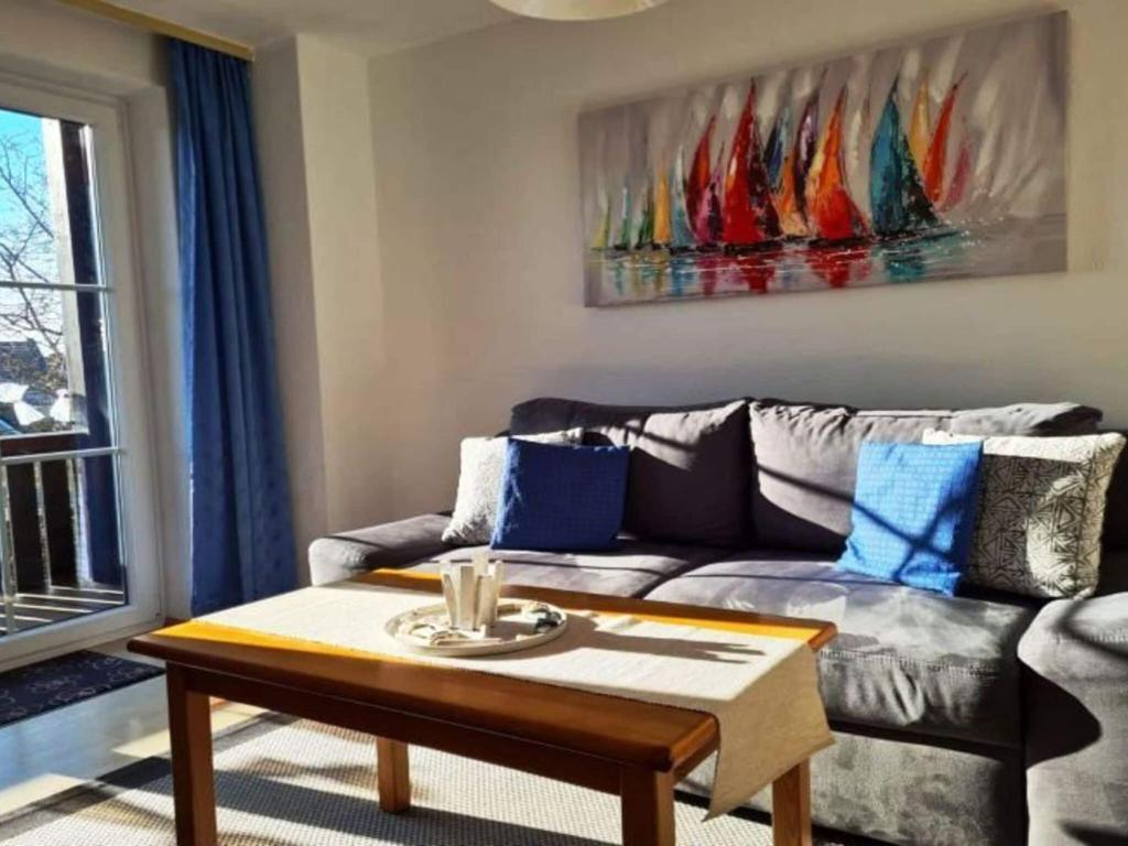 a living room with a couch and a table at Ferienwohnung in Lemkenhafen for 2 Personen in Lemkenhafen auf Fehmarn