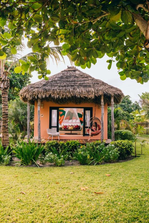 a small gazebo with a thatch roof at Matachica Beach Resort and Spa in San Pedro