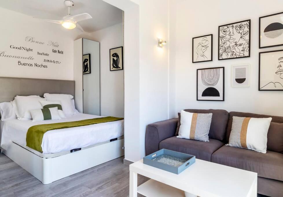 a bedroom with a bed and a couch at Apartment Pink Vistalegre in Torrevieja