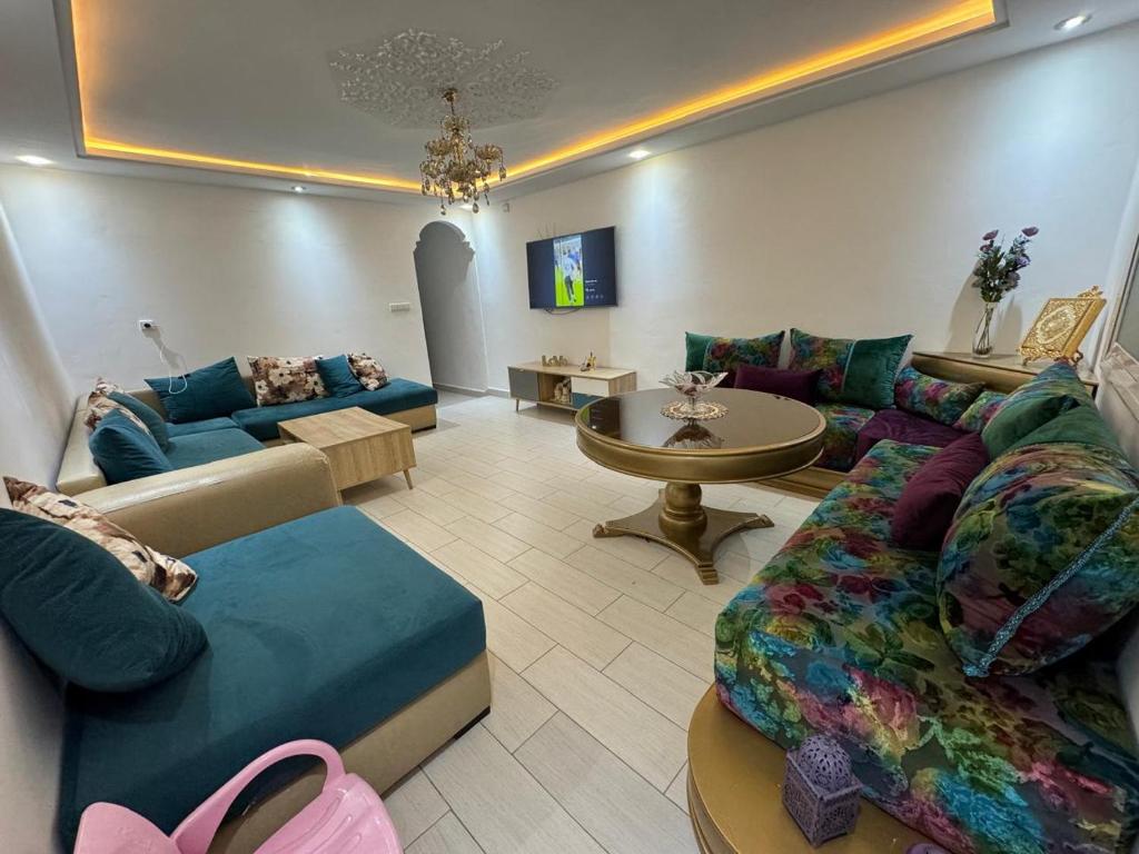 a living room with a couch and a table at City Apartment in M'diq