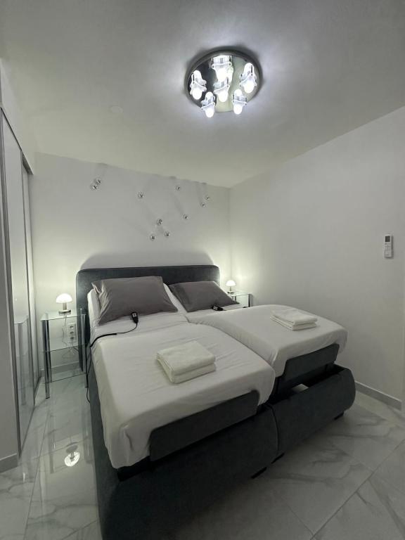 a bedroom with a large bed in a white room at GALAXY - Futuristic apartment SPLIT in Split