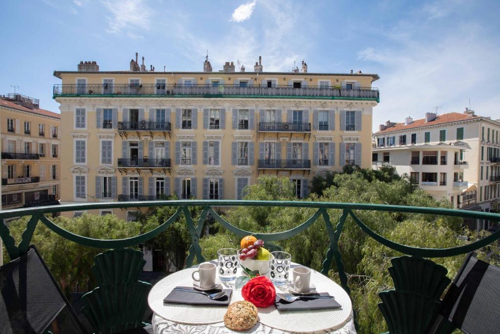 - une table avec de la nourriture au-dessus d'un balcon avec un bâtiment dans l'établissement Le Magenta - Happy Rentals, à Nice