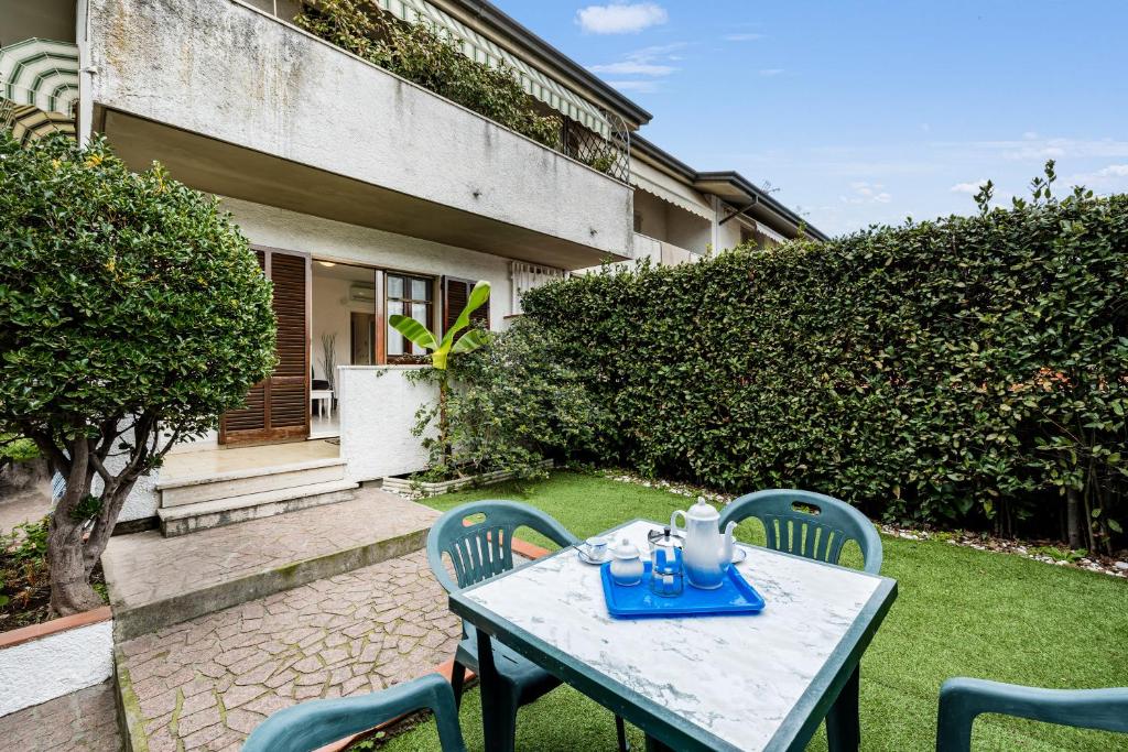 a table and chairs in the yard of a house at Casa al Ponte dei Marmi - few KM to sea - Happy Rentals in Seravezza