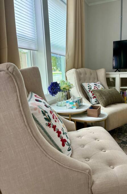 a living room with two chairs and a table at Updated, Fenced, Pet Friendly Downtown Cottage in Southern Pines