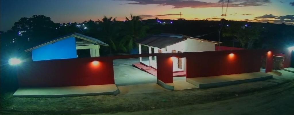 a house with a blue light on it at night at POUSADA DOS REIS in Salinópolis