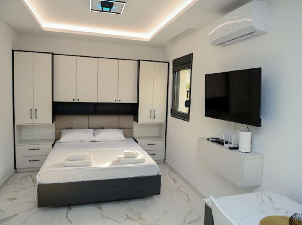 Ένα ή περισσότερα κρεβάτια σε δωμάτιο στο Merlin Prestige Apartments