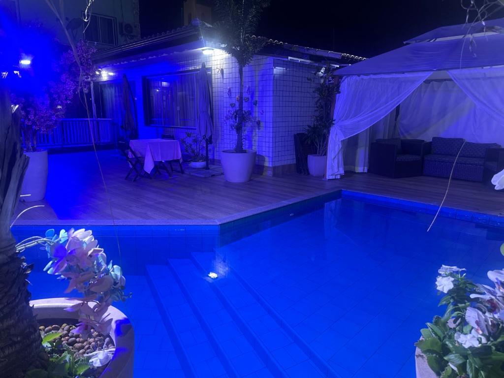 a swimming pool at night with a tent at Hotel Pousada Irmaos Freyhardt in Rio de Janeiro