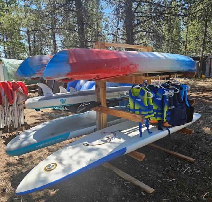 a group of kayaks and backpacks on a rack at Beautiful Riverfront Near Mt Bachelor with Hot Tub in Bend